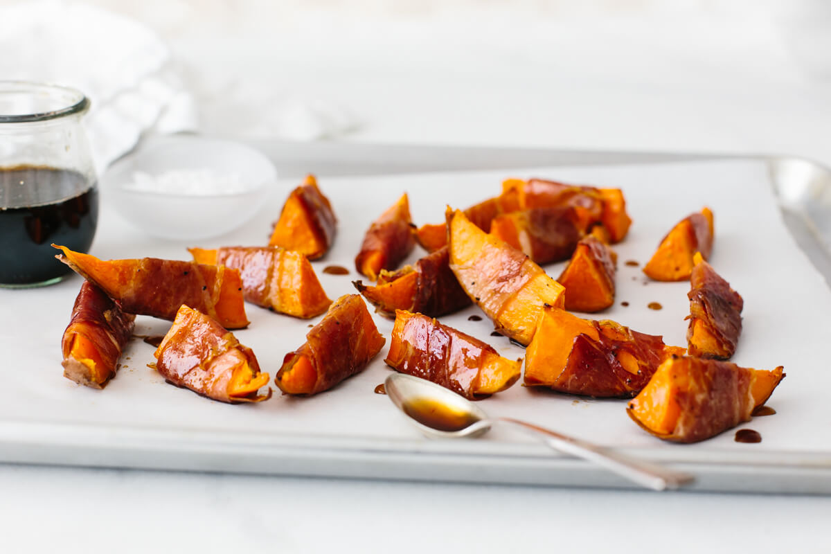 Prosciutto wrapped sweet potatoes drizzled with maple balsamic glaze.